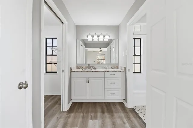 a bathroom with a sink mirror and window