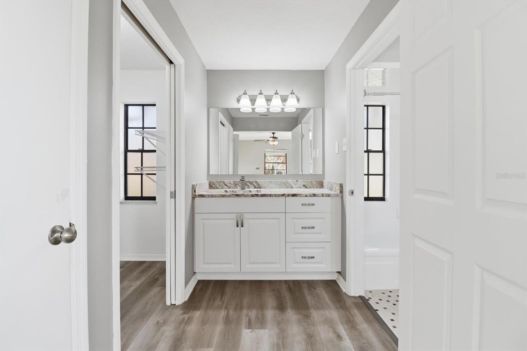 10256 East Pike Drive Inverness, FL 34450 - Photo 13 of 37 a bathroom with a sink mirror and window