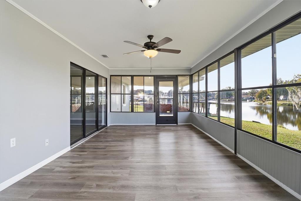 10256 East Pike Drive Inverness, FL 34450 - Photo 17 of 37 wooden floor in an empty room with a window