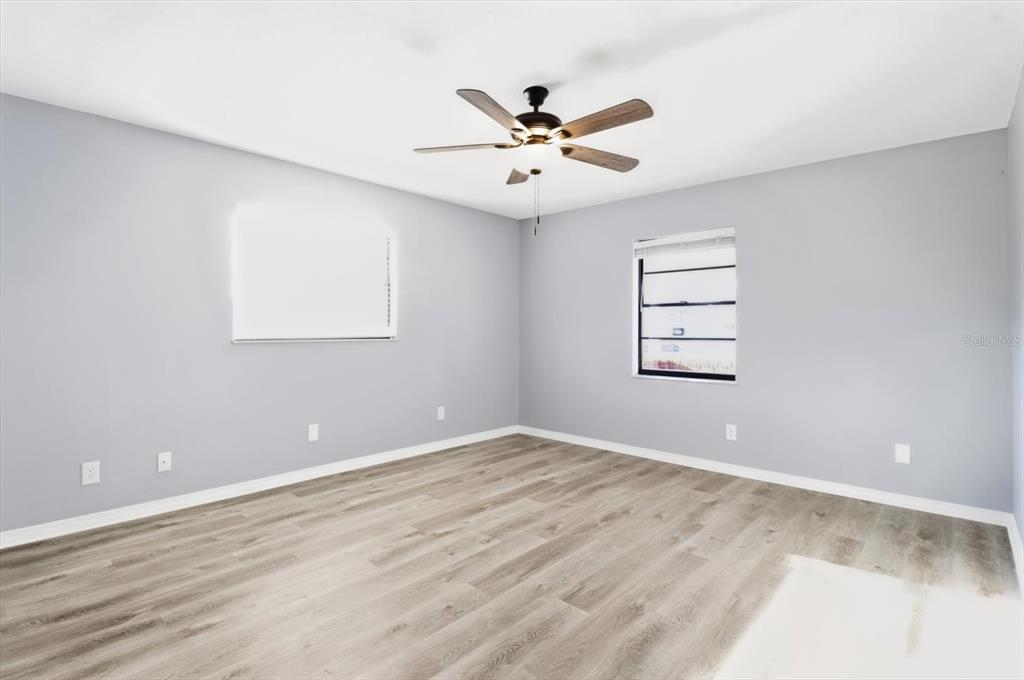10256 East Pike Drive Inverness, FL 34450 - Photo 19 of 37 an empty room with windows and fan