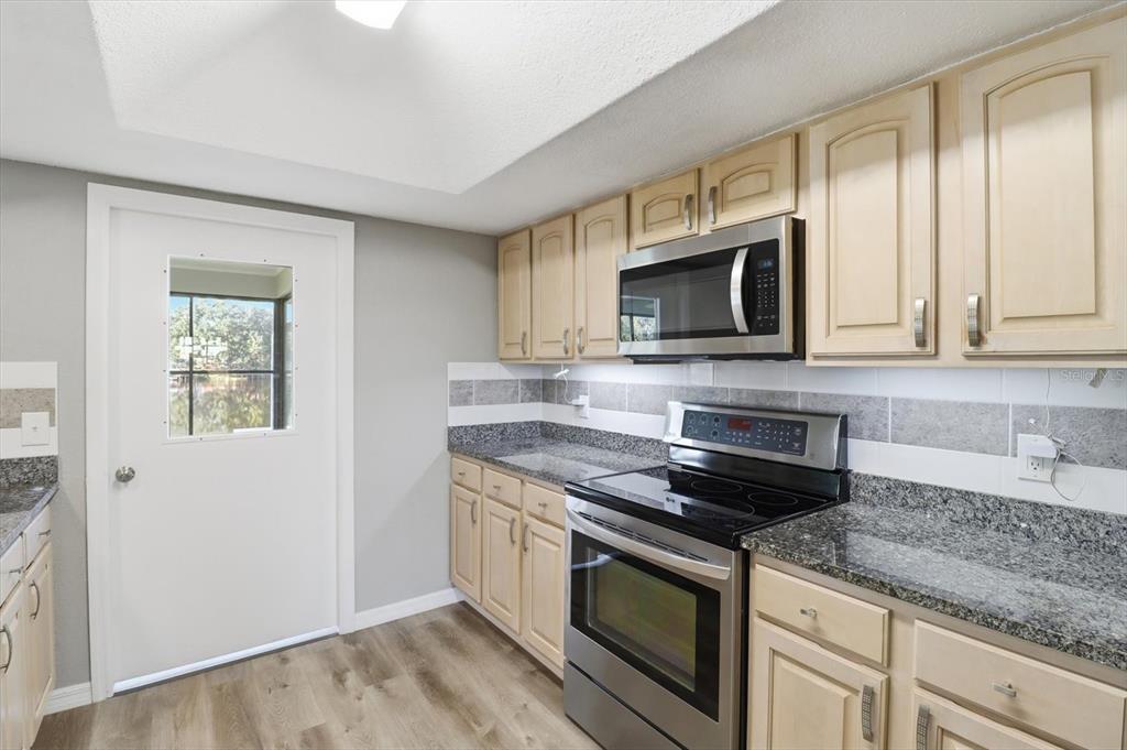 10256 East Pike Drive Inverness, FL 34450 - Photo 22 of 37 a kitchen with appliances a sink and cabinets
