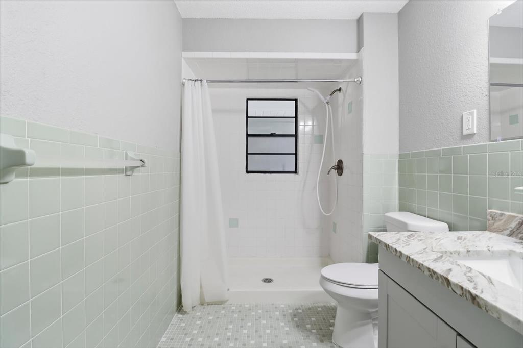 10256 East Pike Drive Inverness, FL 34450 - Photo 26 of 37 a bathroom with a granite countertop sink a toilet and shower
