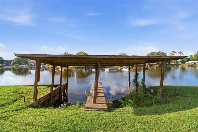 an aerial view of a house with garden space and lake view