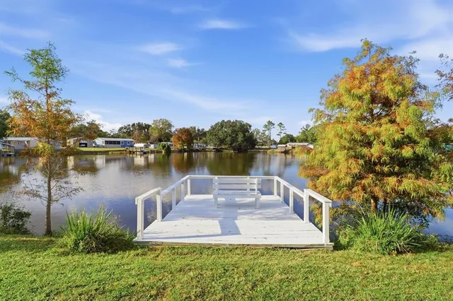 a view of a lake with houses in back