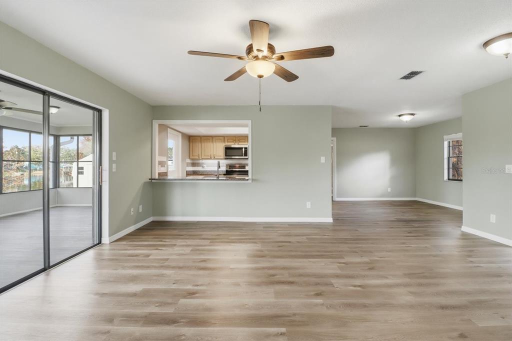 10256 East Pike Drive Inverness, FL 34450 - Photo 6 of 37 a view of an empty room with window and wooden floor