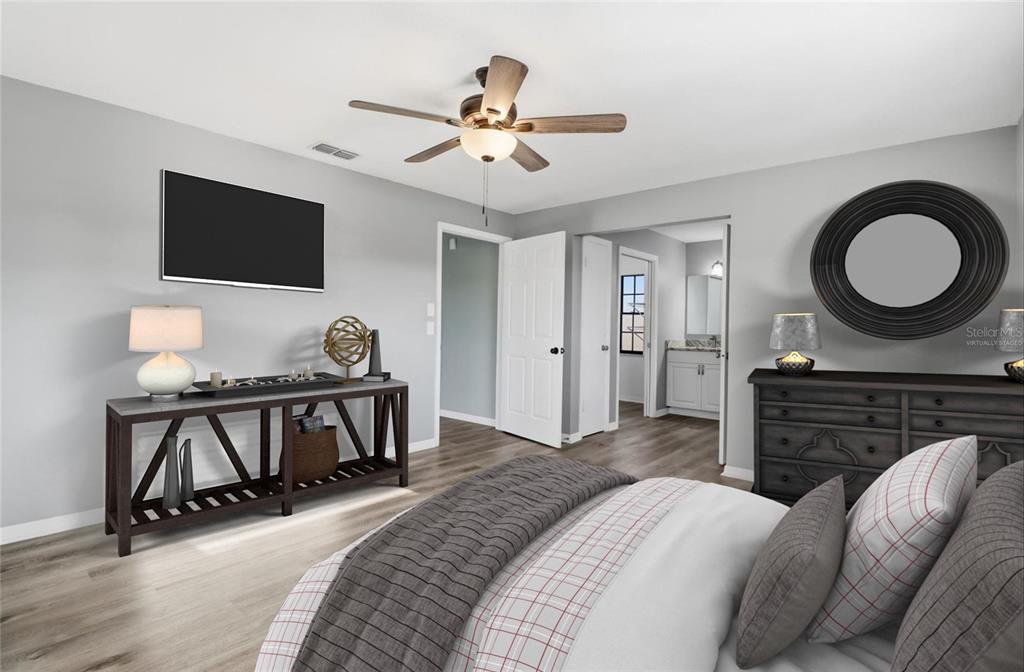 10256 East Pike Drive Inverness, FL 34450 - Photo 10 of 37 a bedroom with a bed and a chandelier