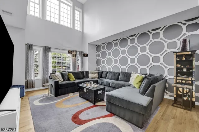 a living room with furniture and painting on the wall