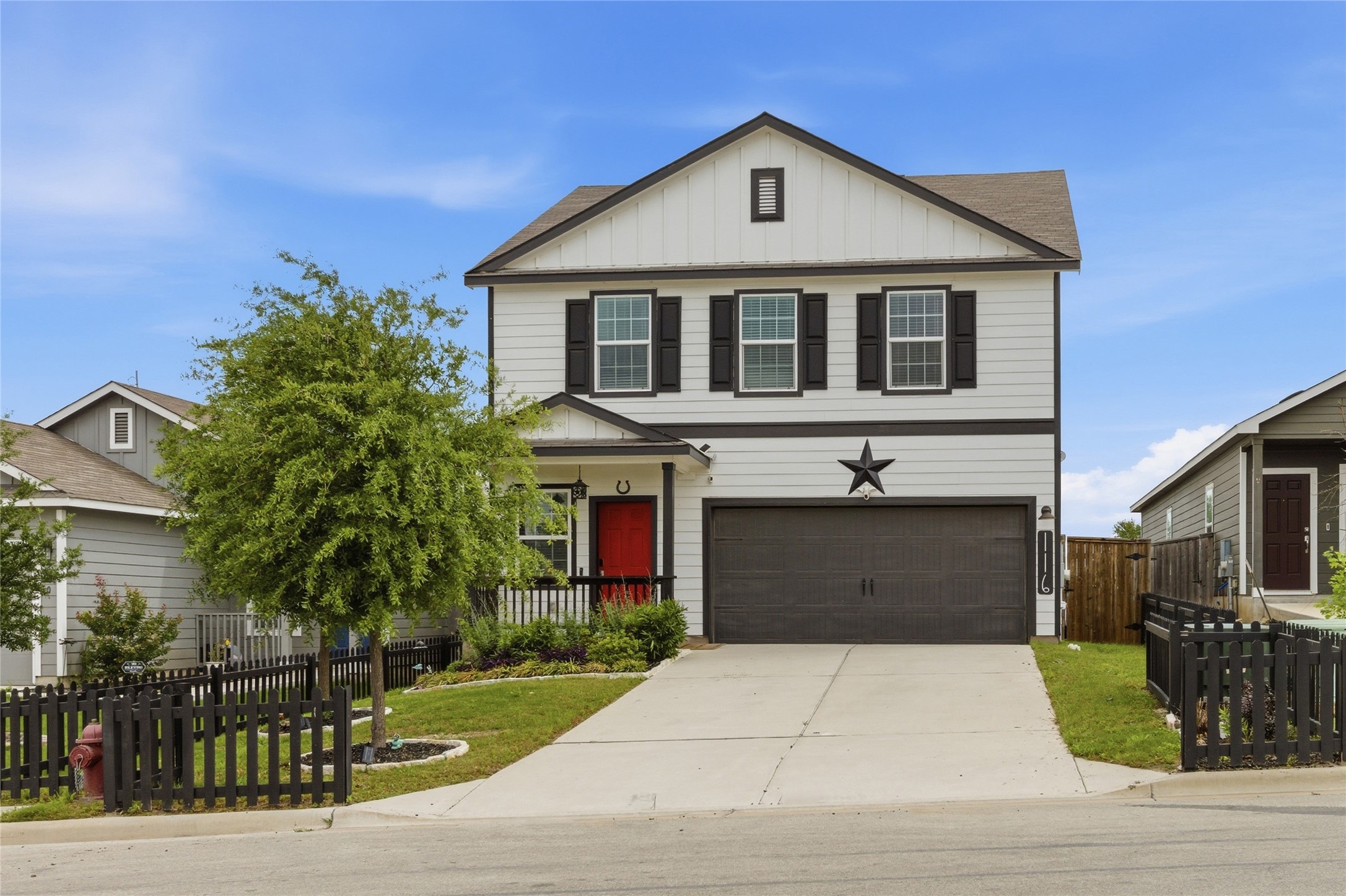 116 Night Riders Way Jarrell, TX 76537 - Photo 4 of 40 Two-story residence featuring white siding with black trim accents and a contrasting red front door