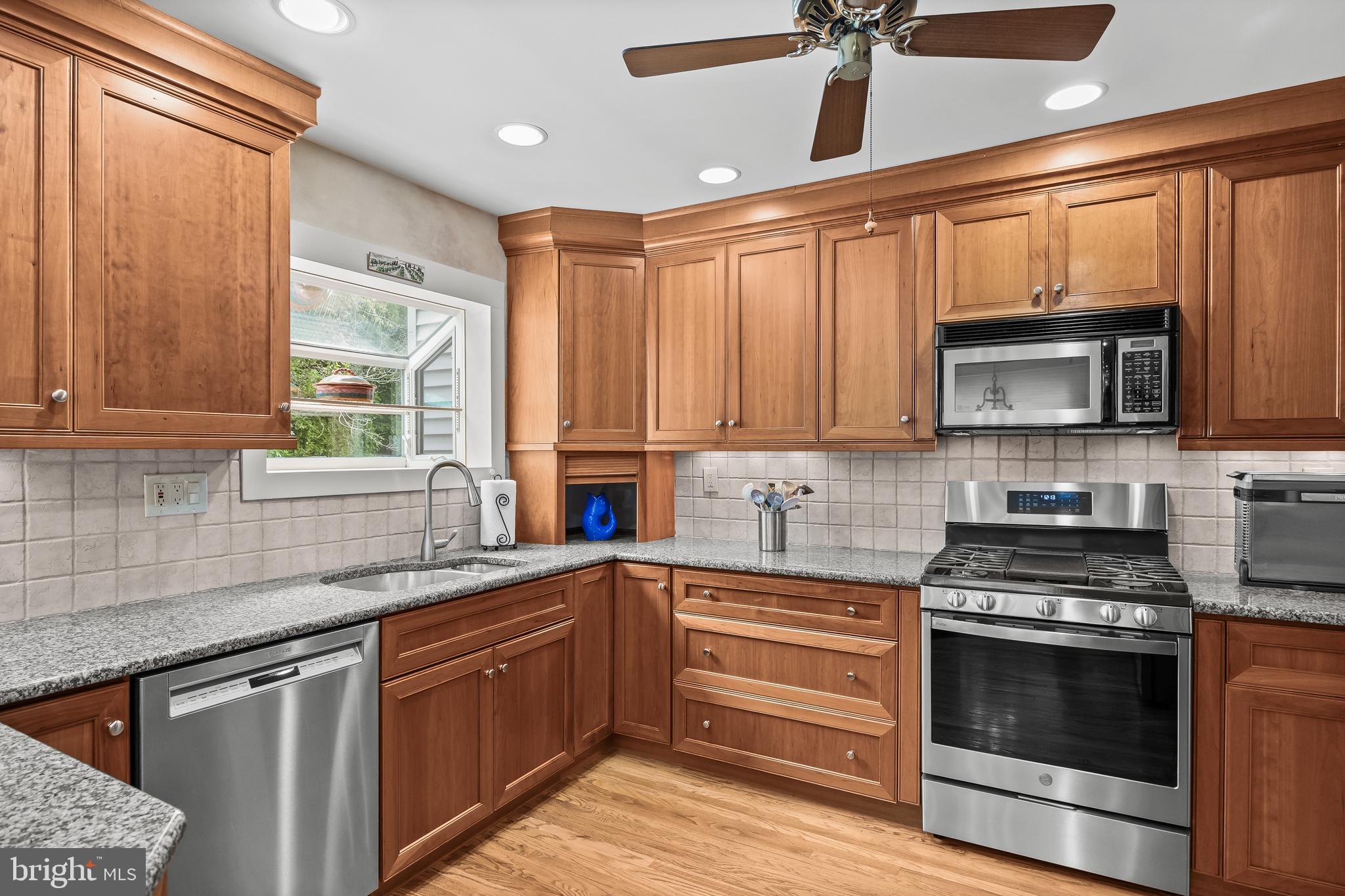 47 Clemson Road Cherry Hill, NJ 08034 - Photo 13 of 50 a kitchen with stainless steel appliances a stove sink microwave and cabinets