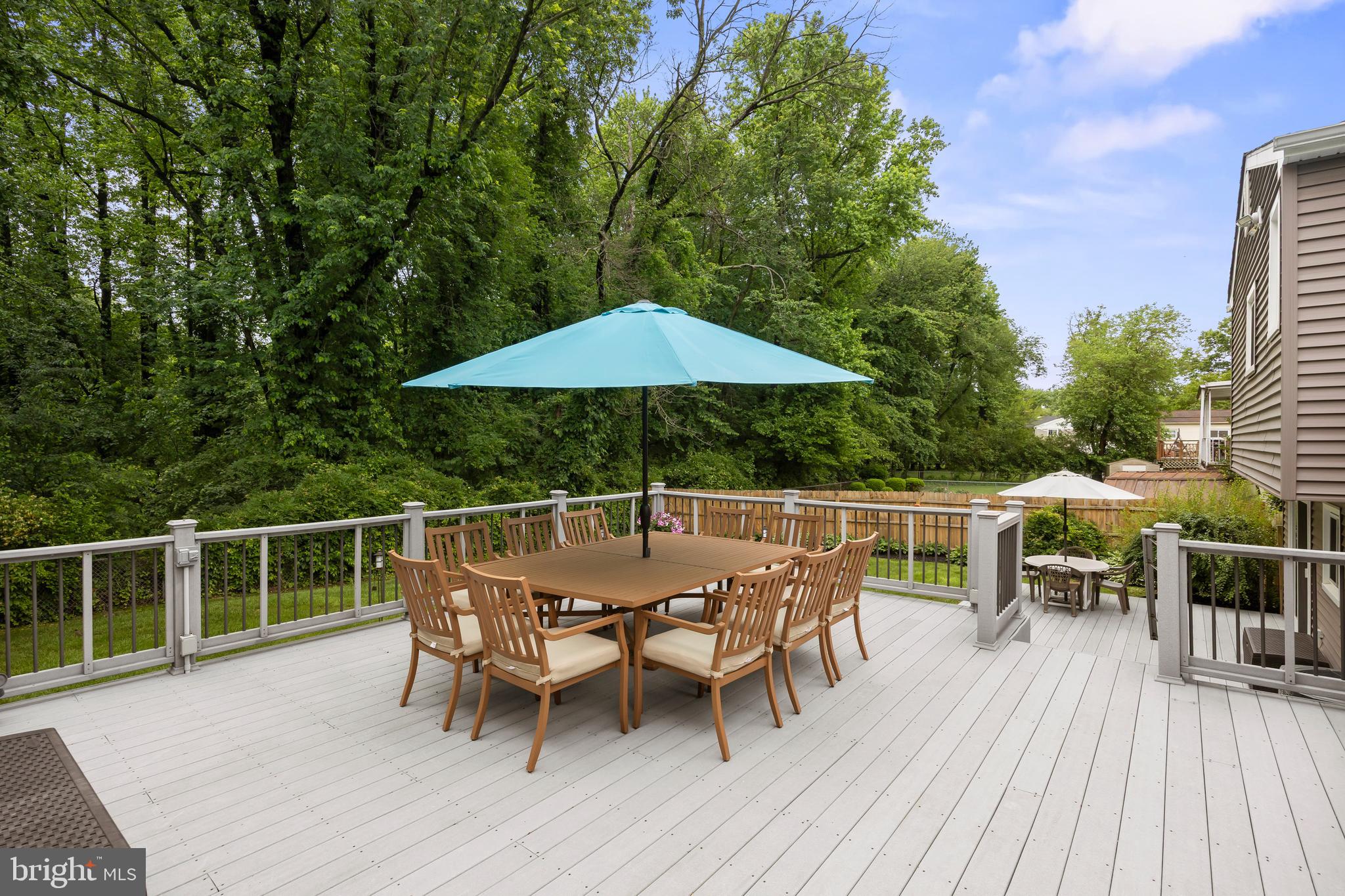 47 Clemson Road Cherry Hill, NJ 08034 - Photo 37 of 50 a patio with wooden floor a yard a table and chairs