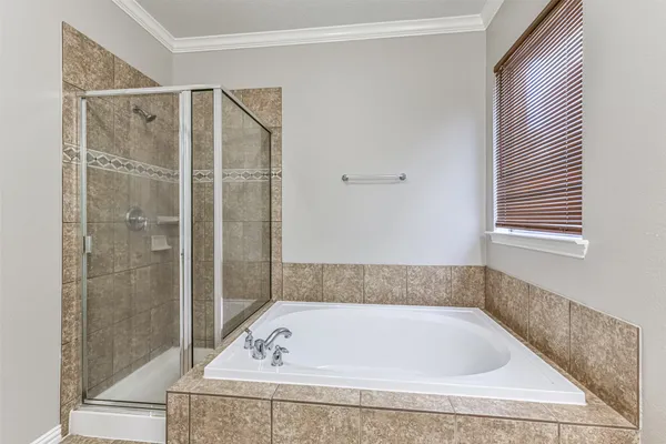 a spacious bathroom with a double vanity sink mirror and shower