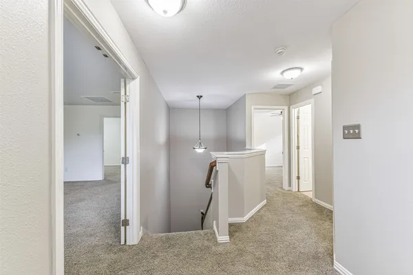a view of staircase with white walls and a window