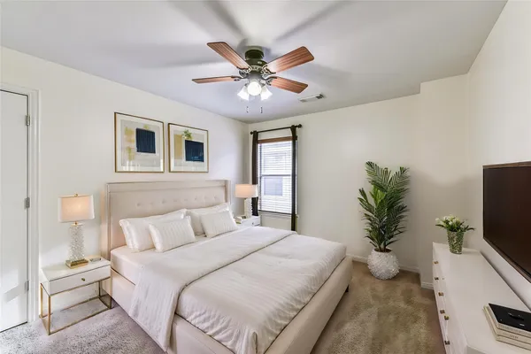 a bedroom with a bed and window