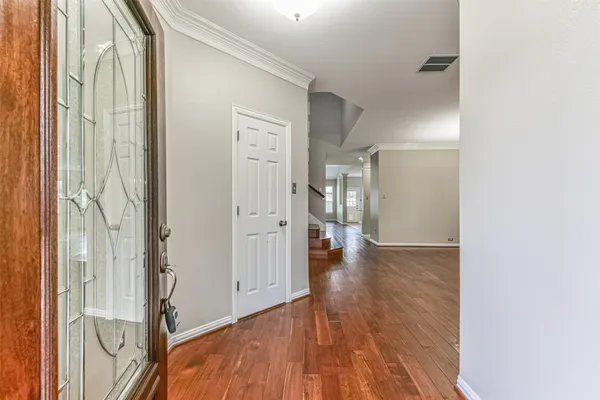 a view of a hallway with wooden floor