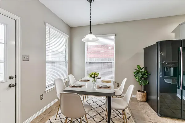 a dining room with furniture potted plants and wooden floor