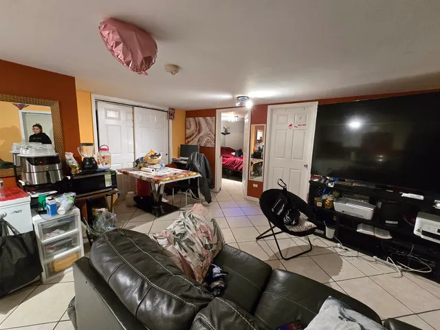 a outdoor living room with furniture and a flat screen tv