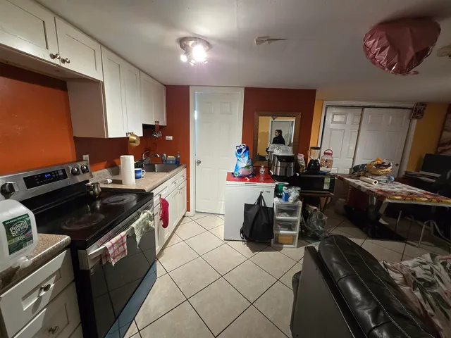 a kitchen with a stove and a refrigerator