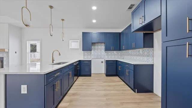 a large kitchen with stainless steel appliances kitchen island granite countertop a sink stove and wooden cabinets