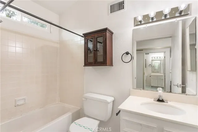 a bathroom with a sink double vanity and a mirror