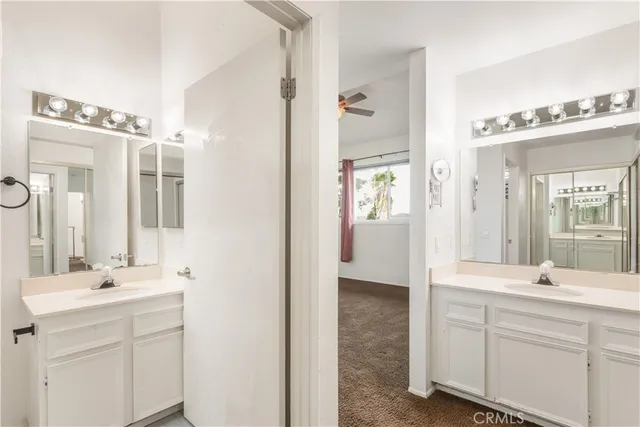 an empty room with windows and ceiling fan