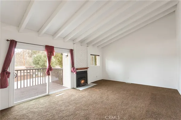 an empty room with furniture and a fireplace