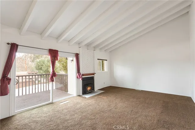 an empty room with furniture and a fireplace