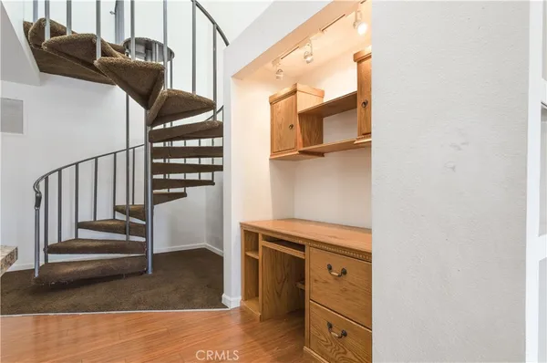 a large kitchen with a wooden floor and cabinets