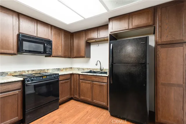 a view of a livingroom with wooden floor and a ceiling fan
