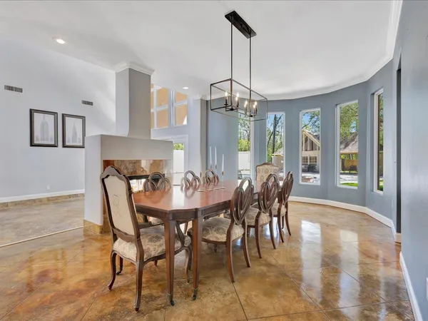 a view of a dining room with furniture and chandelier