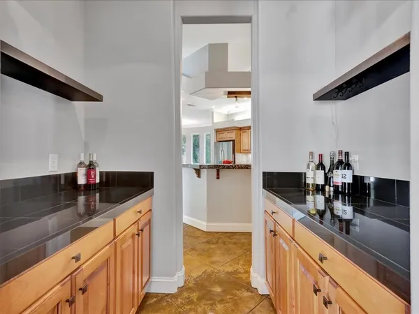 a kitchen with granite countertop a sink and cabinets