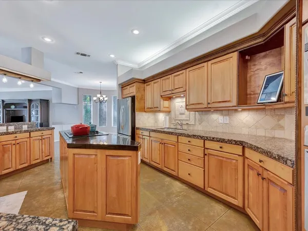 a kitchen with granite countertop a sink and cabinets