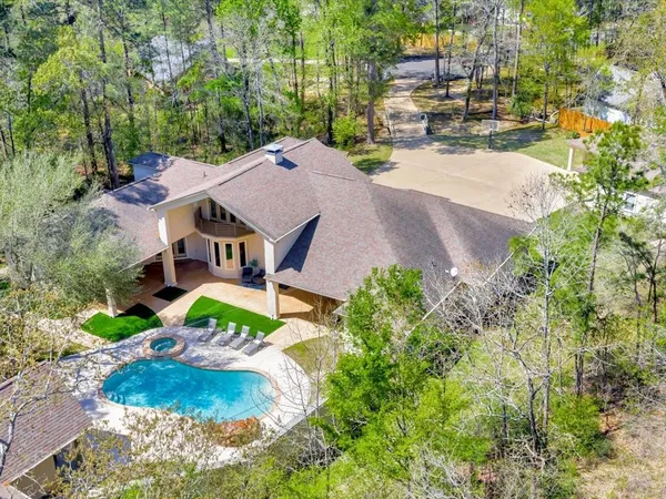 an aerial view of a house with a yard basket ball court and outdoor seating