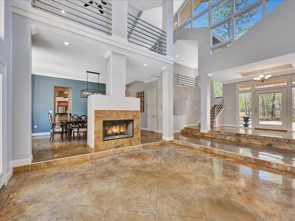 a view of a livingroom with a fireplace and chandelier