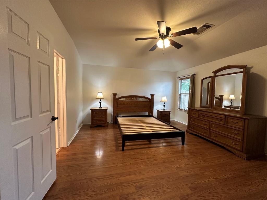3412 Napa Valley Bend Leander, TX 78641 - Photo 19 of 27 Bedroom featuring dark wood-style floors and a ceiling fan