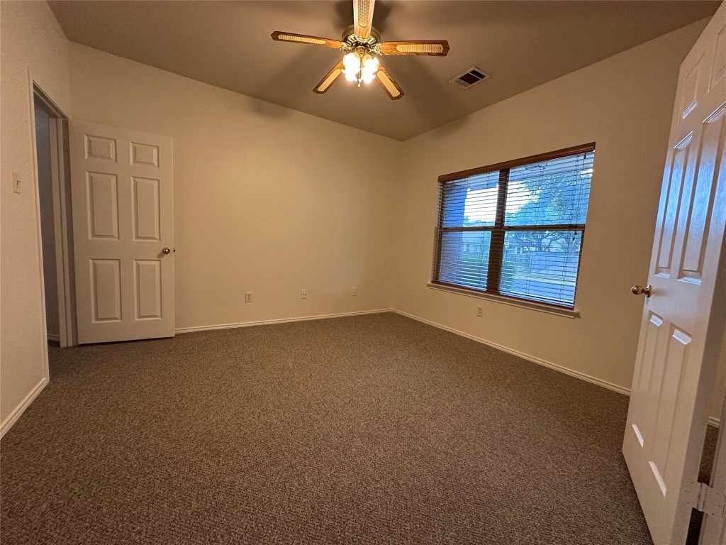 3412 Napa Valley Bend Leander, TX 78641 - Photo 3 of 27 Unfurnished room with dark colored carpet and a ceiling fan