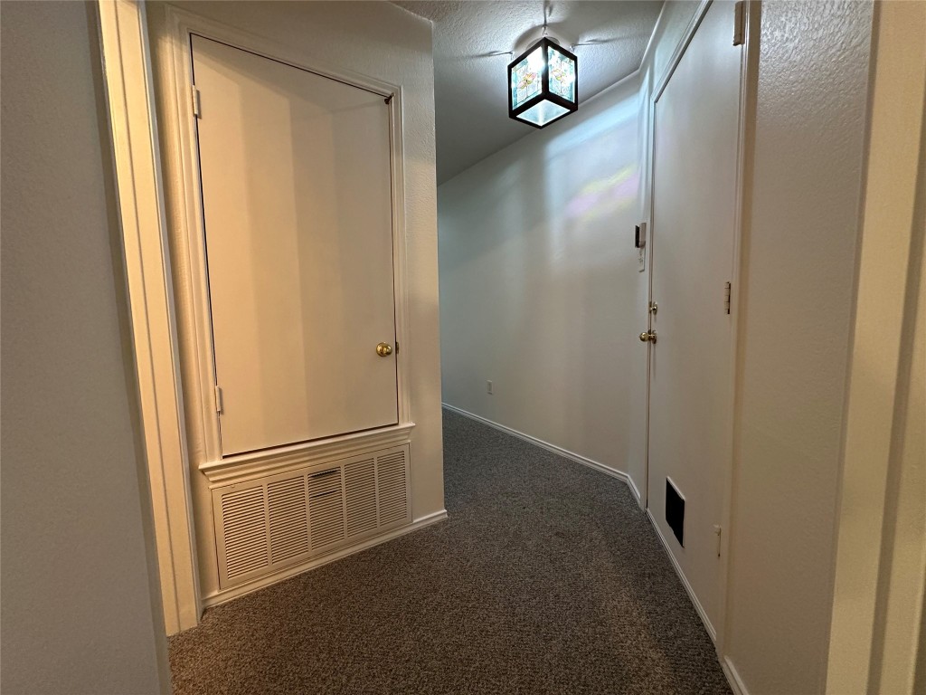 3412 Napa Valley Bend Leander, TX 78641 - Photo 6 of 27 Corridor with dark colored carpet and baseboards