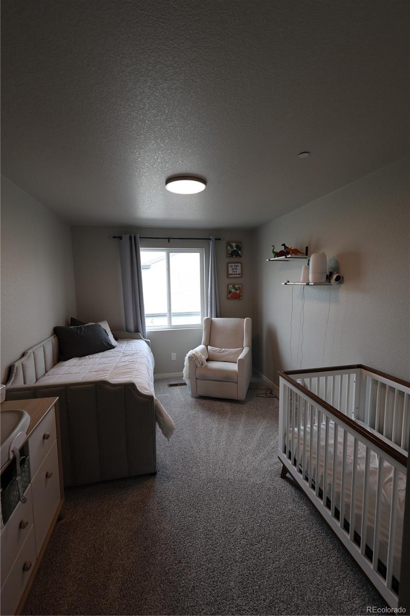 6719 4th St Road, Unit 2 Greeley, CO 80634 - Photo 12 of 23 a bedroom with a bed and a window