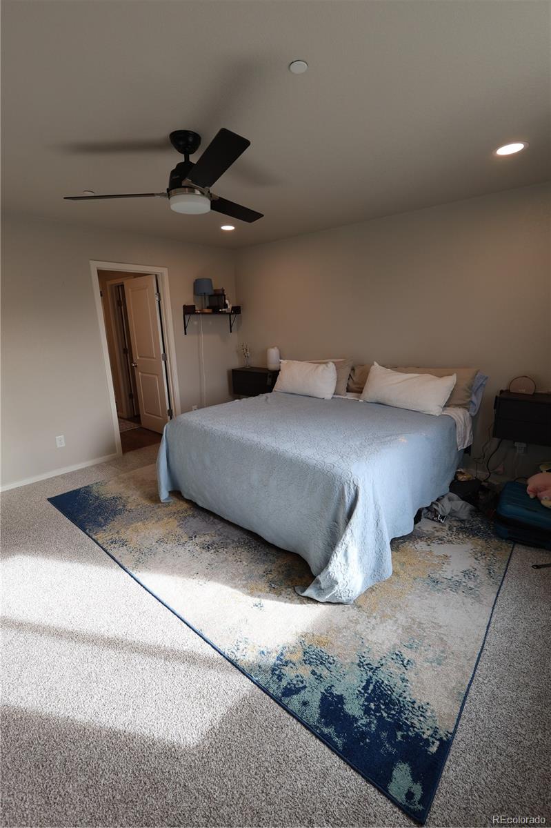 6719 4th St Road, Unit 2 Greeley, CO 80634 - Photo 16 of 23 a bedroom with bed and a chandelier