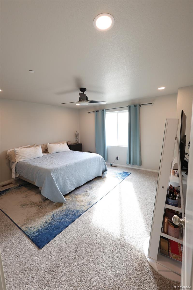 6719 4th St Road, Unit 2 Greeley, CO 80634 - Photo 17 of 23 a bedroom with a bed and a flat tv screen on a dresser