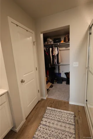 a view of walk in closet with clothes and shoes