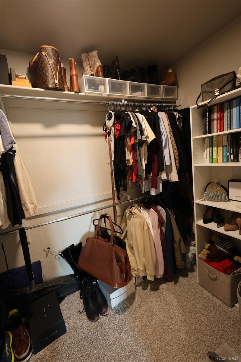 6719 4th St Road, Unit 2 Greeley, CO 80634 - Photo 20 of 23 a view of walk in closet with clothes and shoes