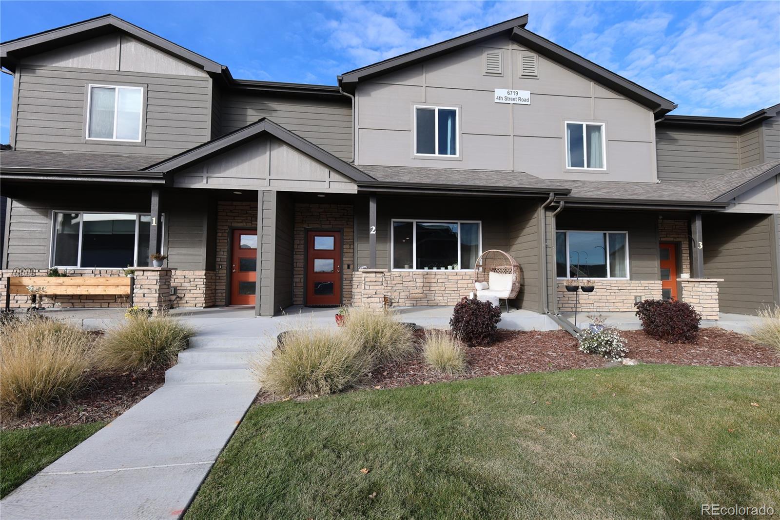 6719 4th St Road, Unit 2 Greeley, CO 80634 - Photo 2 of 23 a front view of a house with garden