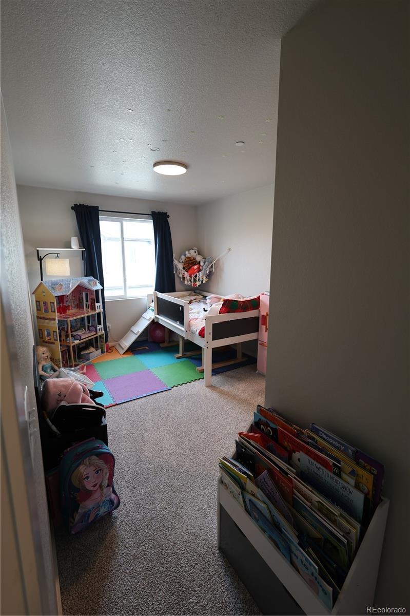 6719 4th St Road, Unit 2 Greeley, CO 80634 - Photo 23 of 23 a living room with furniture and a wooden floor