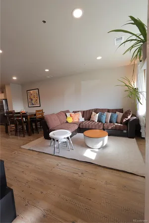 a kitchen with a dining table chairs and flat screen tv