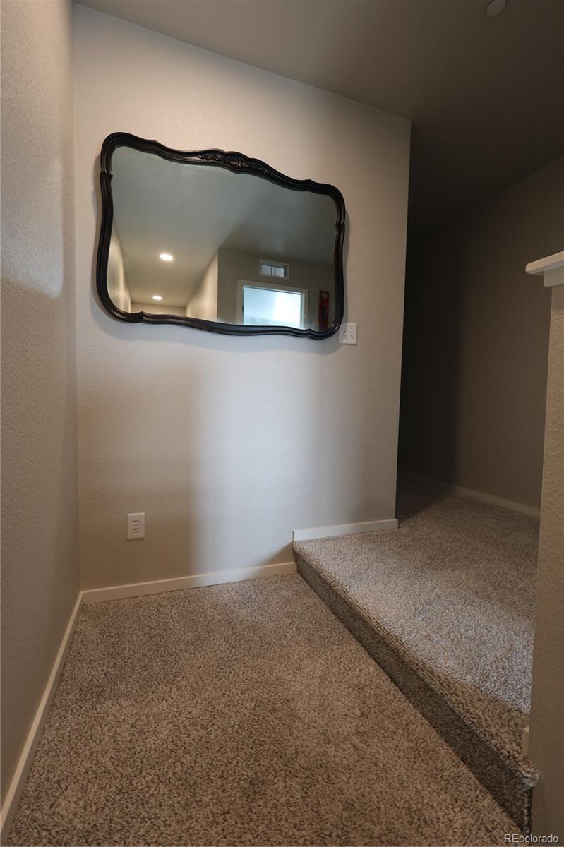 6719 4th St Road, Unit 2 Greeley, CO 80634 - Photo 10 of 23 a bedroom with a car and mirror