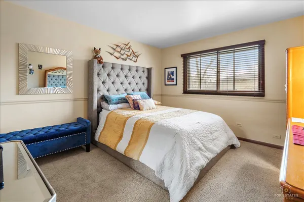 a bedroom with a bed and a dresser