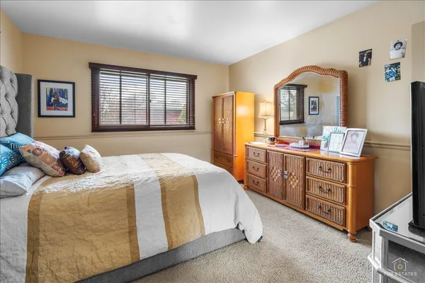 a bedroom with a bed and a large mirror