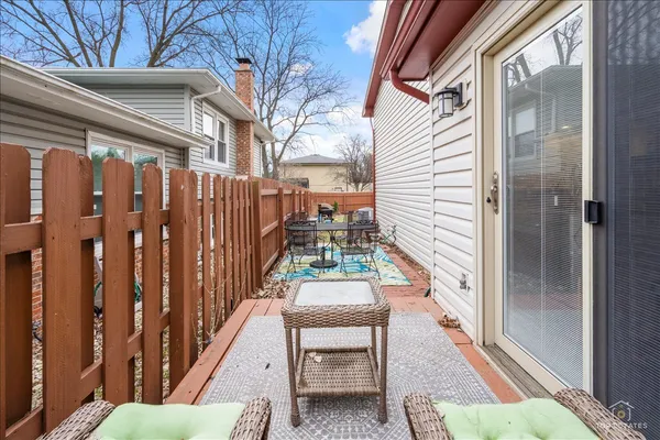 a view of balcony with wooden floor and fence