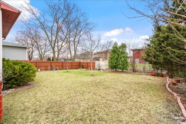 a view of a house with a yard and garage
