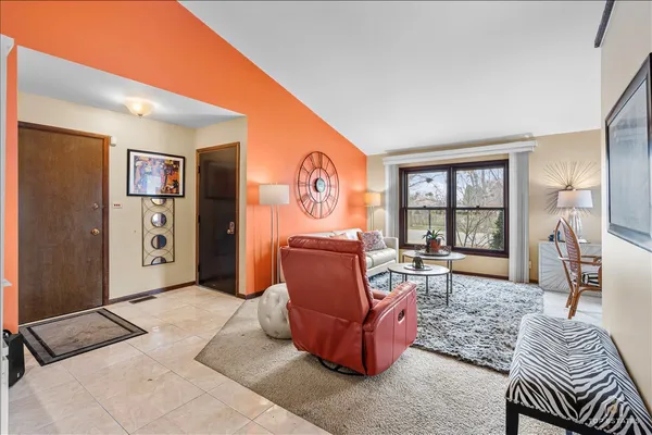 a living room with furniture and a floor to ceiling window